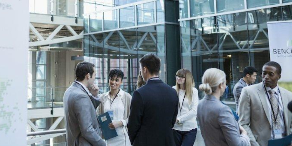  A Group of People & Graduates Attending & Discussing In The Mega Job Fair Event.